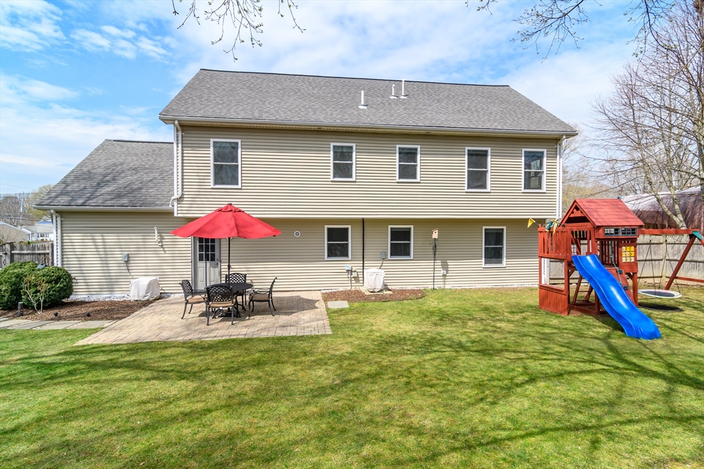 3 Leighton Street Natick, MA 01760 - Photo 29 of 31 a patio with a table and chairs under an umbrella