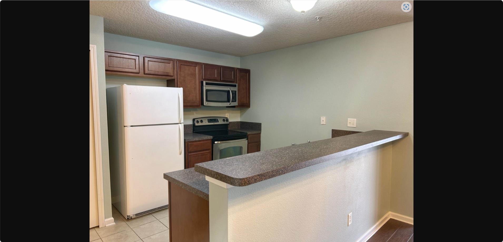 240 Golden Lake Loop St. Augustine, FL 32084 - Photo 14 of 19 a kitchen with a refrigerator and a stove