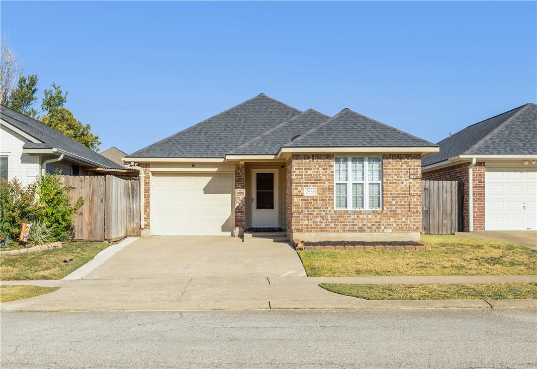 a front view of a house with a yard outdoor seating and garage