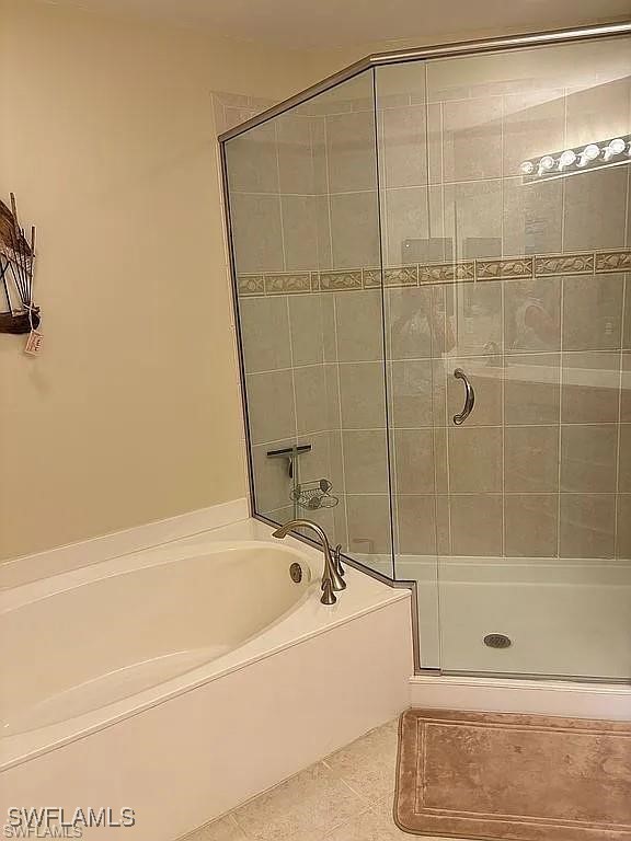 17619 Brickstone Loop Fort Myers, FL 33967 - Photo 19 of 38 a bathroom with a bathtub and a shower