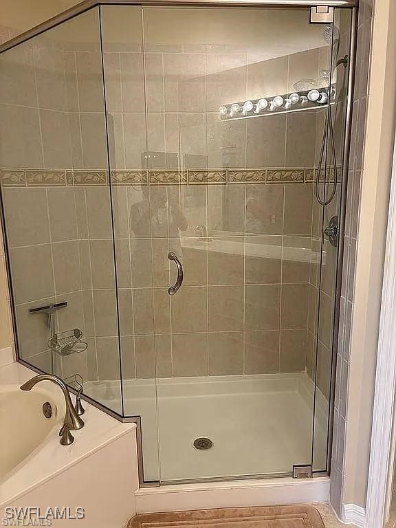 17619 Brickstone Loop Fort Myers, FL 33967 - Photo 20 of 38 a bathroom with a tub and a shower
