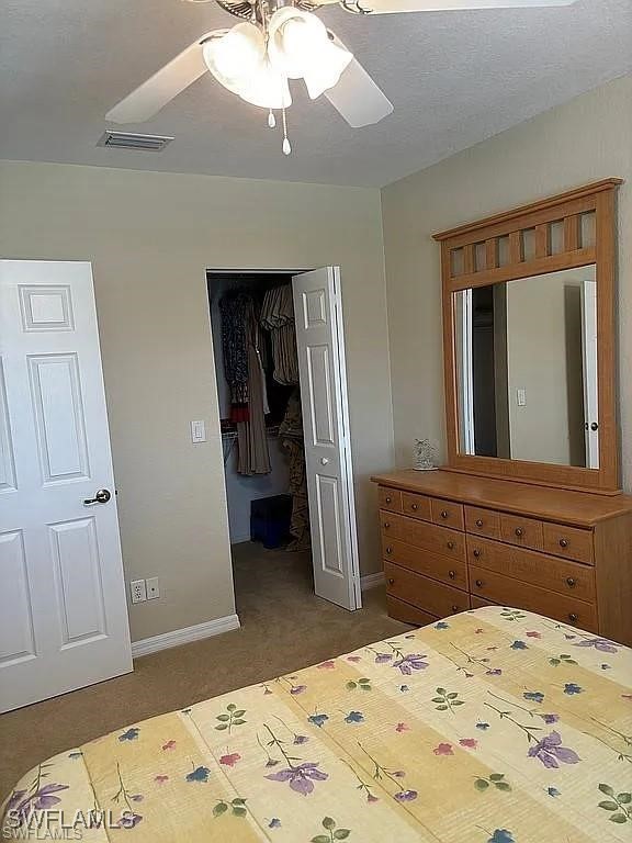 17619 Brickstone Loop Fort Myers, FL 33967 - Photo 24 of 38 a bedroom with a bed and a dresser in it