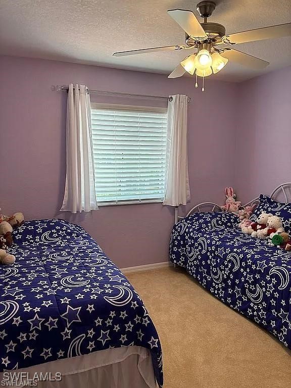 17619 Brickstone Loop Fort Myers, FL 33967 - Photo 25 of 38 a bedroom with a bed and a chandelier