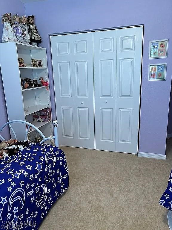 17619 Brickstone Loop Fort Myers, FL 33967 - Photo 26 of 38 a bedroom with a bed and cabinets
