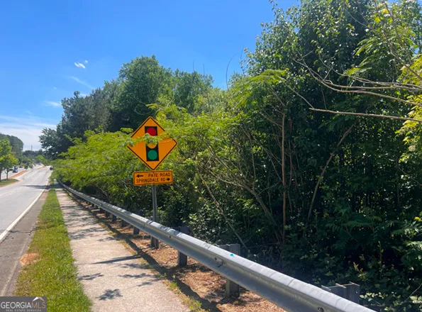 a view of swimming pool with a garden and deck