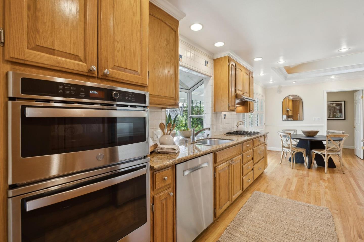 116 Vallecitos Way Los Gatos, CA 95032 - Photo 25 of 66 a kitchen with stainless steel appliances kitchen island granite countertop a stove a sink and a microwave