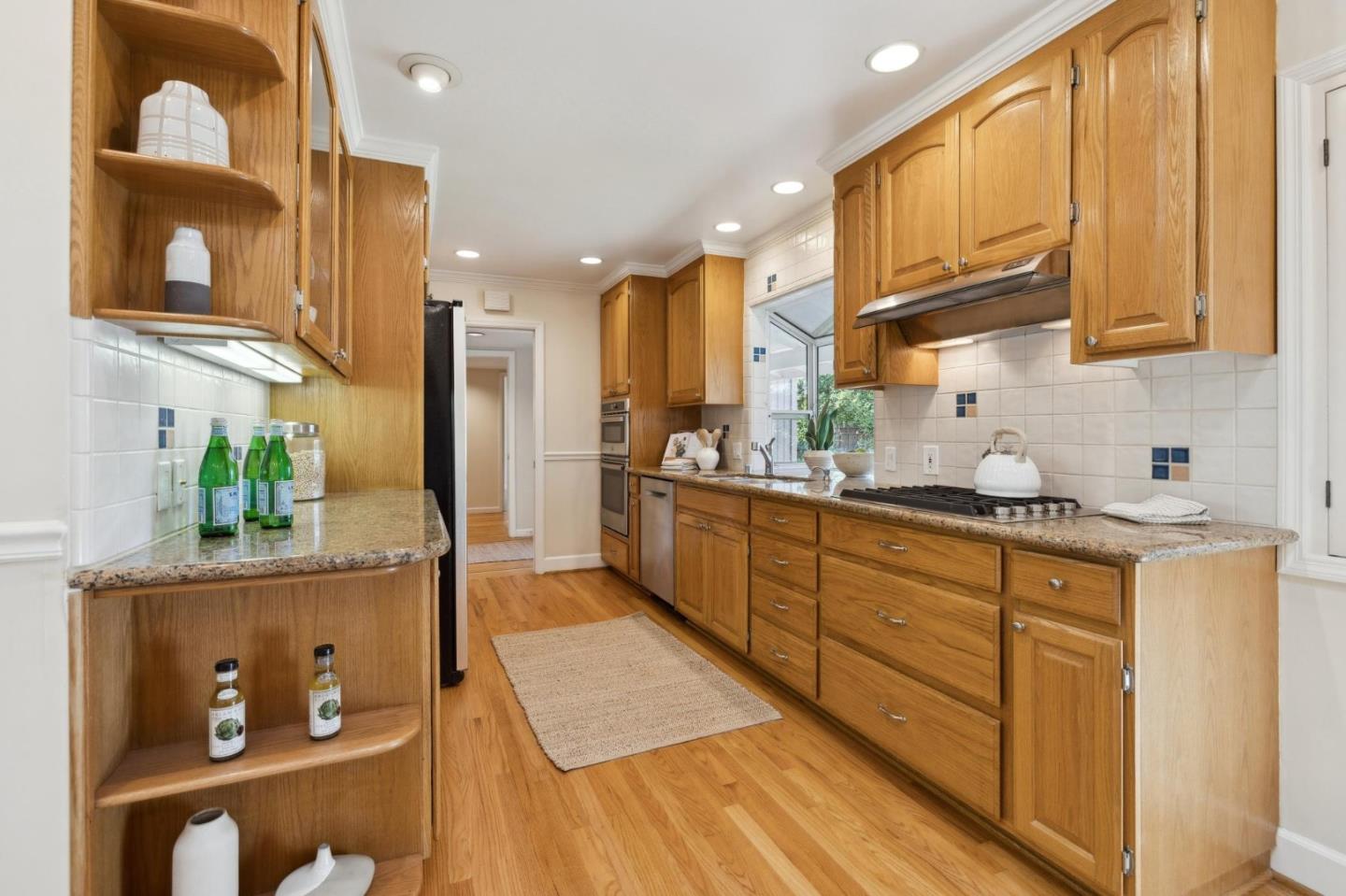 116 Vallecitos Way Los Gatos, CA 95032 - Photo 26 of 66 a kitchen with stainless steel appliances granite countertop lots of counter top space and wooden floor