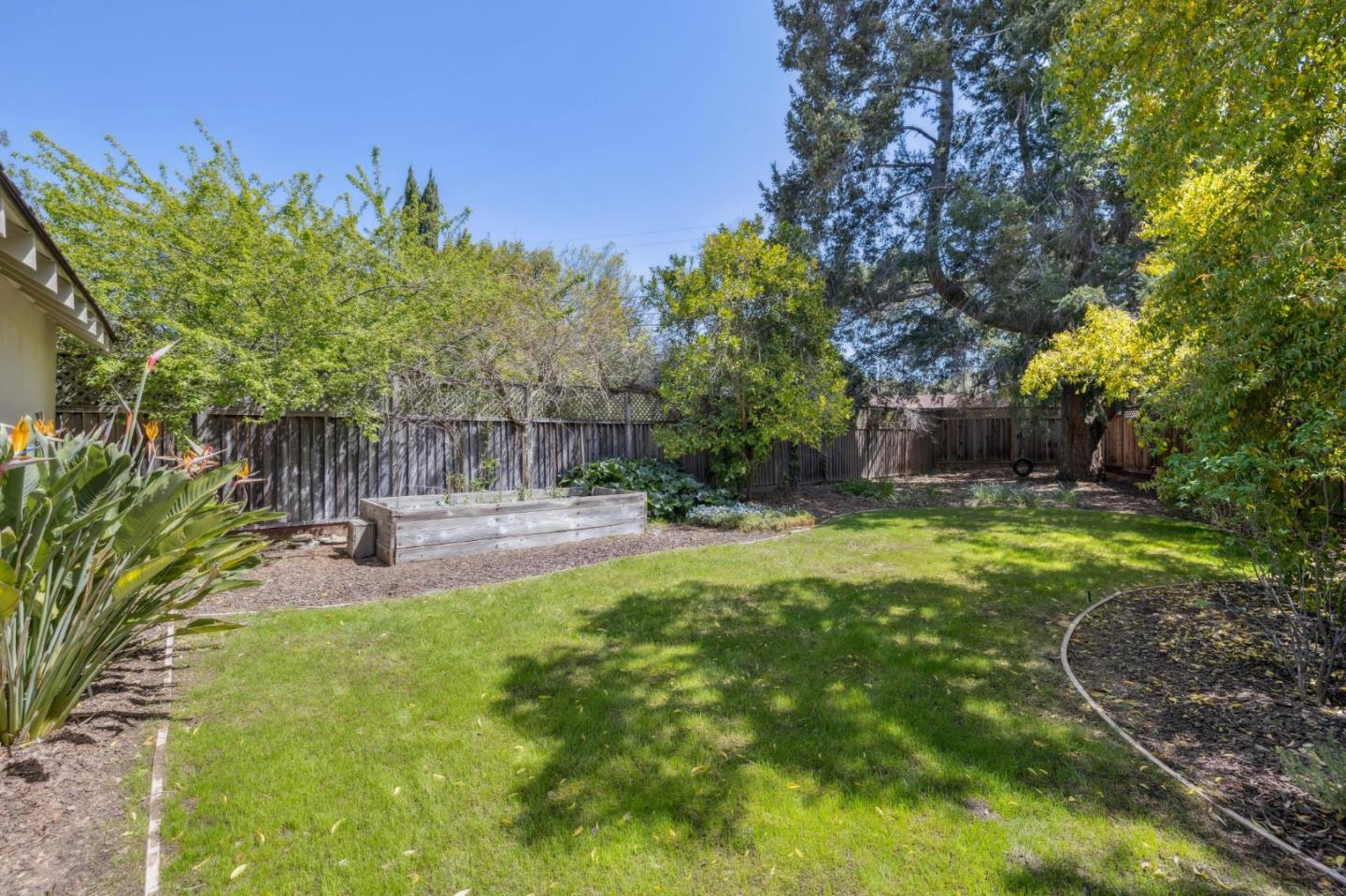116 Vallecitos Way Los Gatos, CA 95032 - Photo 53 of 66 a view of a garden with a bench
