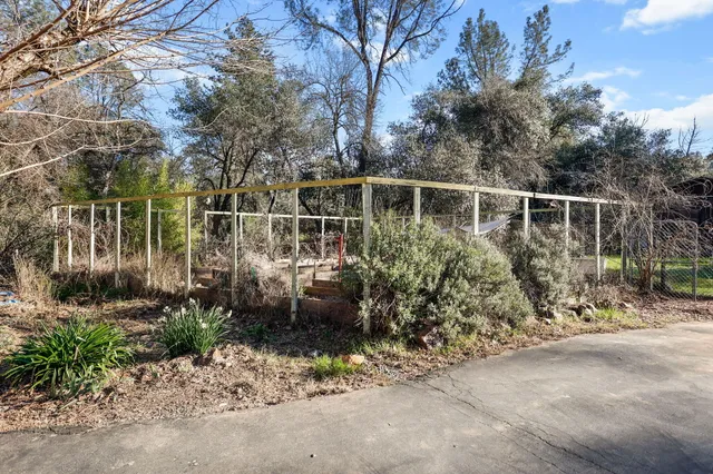 a view of a small house with a trees in the background