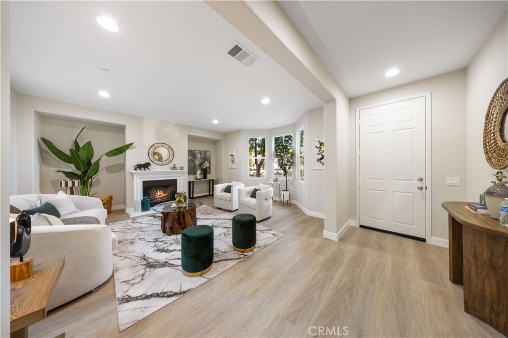 15525 Bonsai Way Tustin, CA 92782 - Photo 16 of 40 a living room with fireplace furniture and a large window