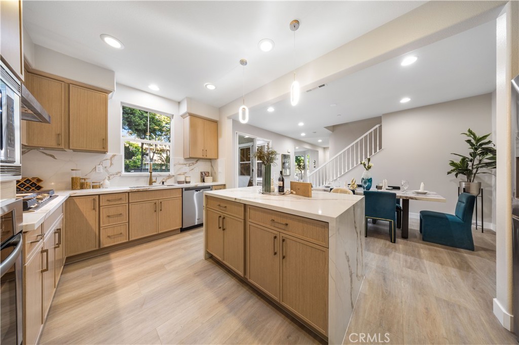 15525 Bonsai Way Tustin, CA 92782 - Photo 19 of 40 a kitchen with white cabinets and white appliances