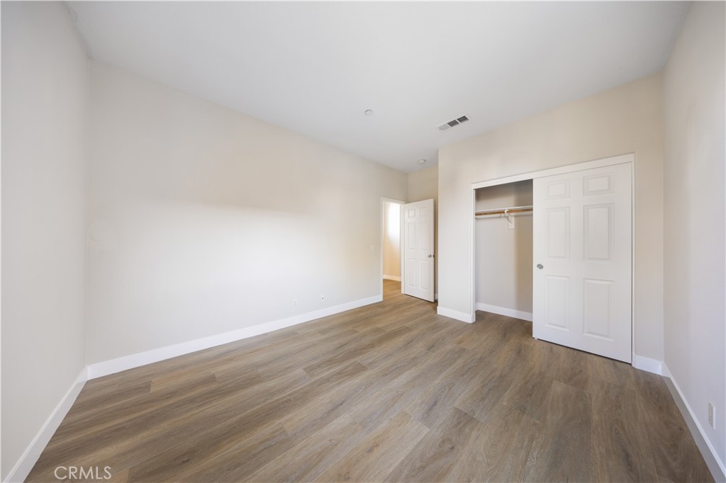 15525 Bonsai Way Tustin, CA 92782 - Photo 21 of 40 a view of an empty room with wooden floor