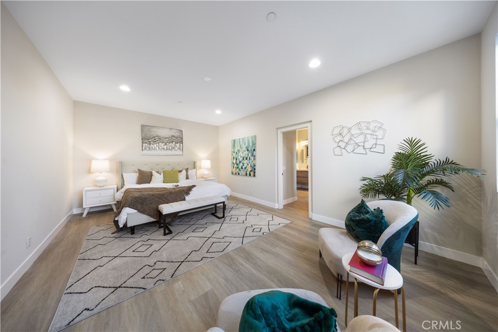15525 Bonsai Way Tustin, CA 92782 - Photo 29 of 40 a bedroom with furniture and a potted plant