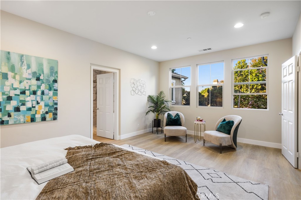 15525 Bonsai Way Tustin, CA 92782 - Photo 31 of 40 a spacious bedroom with a bed and a window