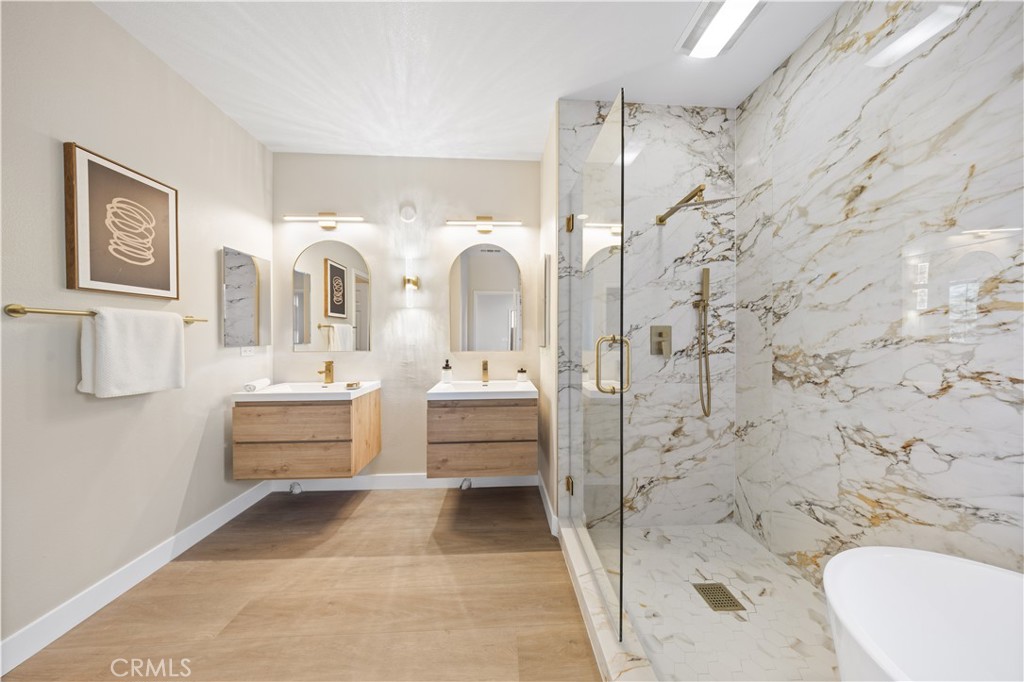 15525 Bonsai Way Tustin, CA 92782 - Photo 32 of 40 a bathroom with a sink a mirror and a shower