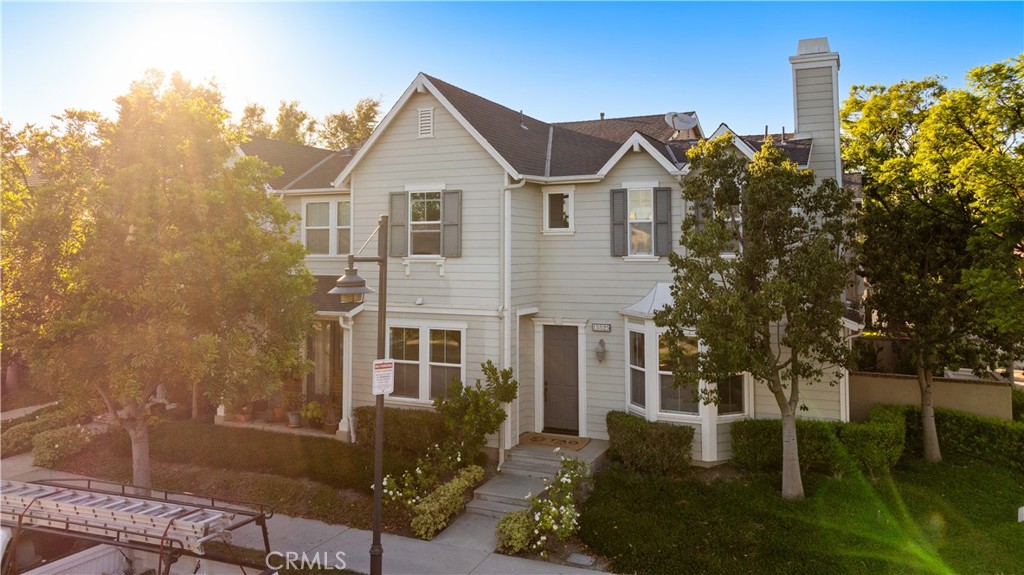 15525 Bonsai Way Tustin, CA 92782 - Photo 40 of 40 a view of a white house next to a yard with plants and trees