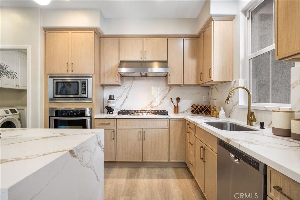 15525 Bonsai Way Tustin, CA 92782 - Photo 10 of 40 a kitchen with a sink stove and cabinets
