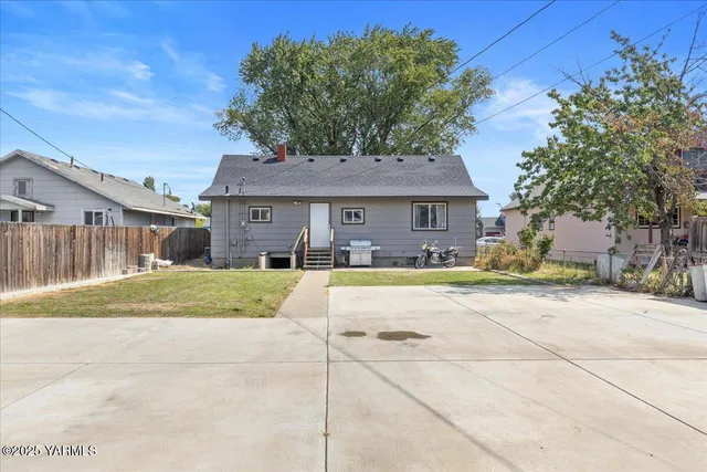 a house view with swimming pool and wooden fence