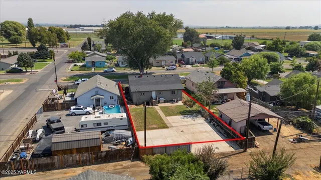 an aerial view of a houses with a city view