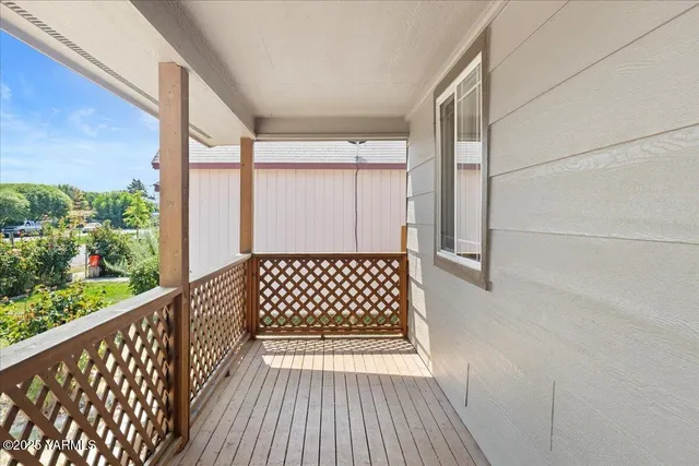 a view of a balcony with wooden floor