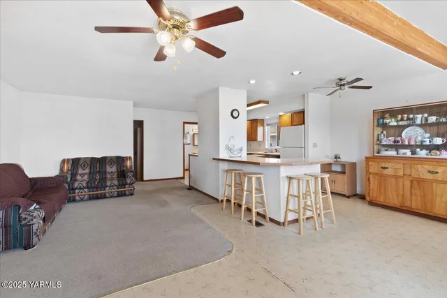 a living room with furniture and kitchen view