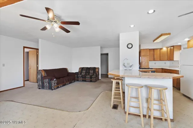 a living room with furniture and a kitchen