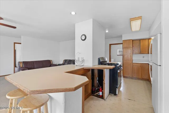 a large kitchen with a table and chairs