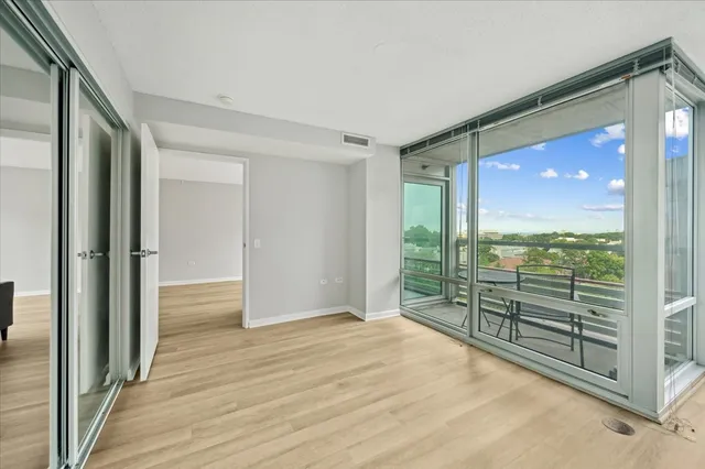 a view of a room with wooden floor and balcony