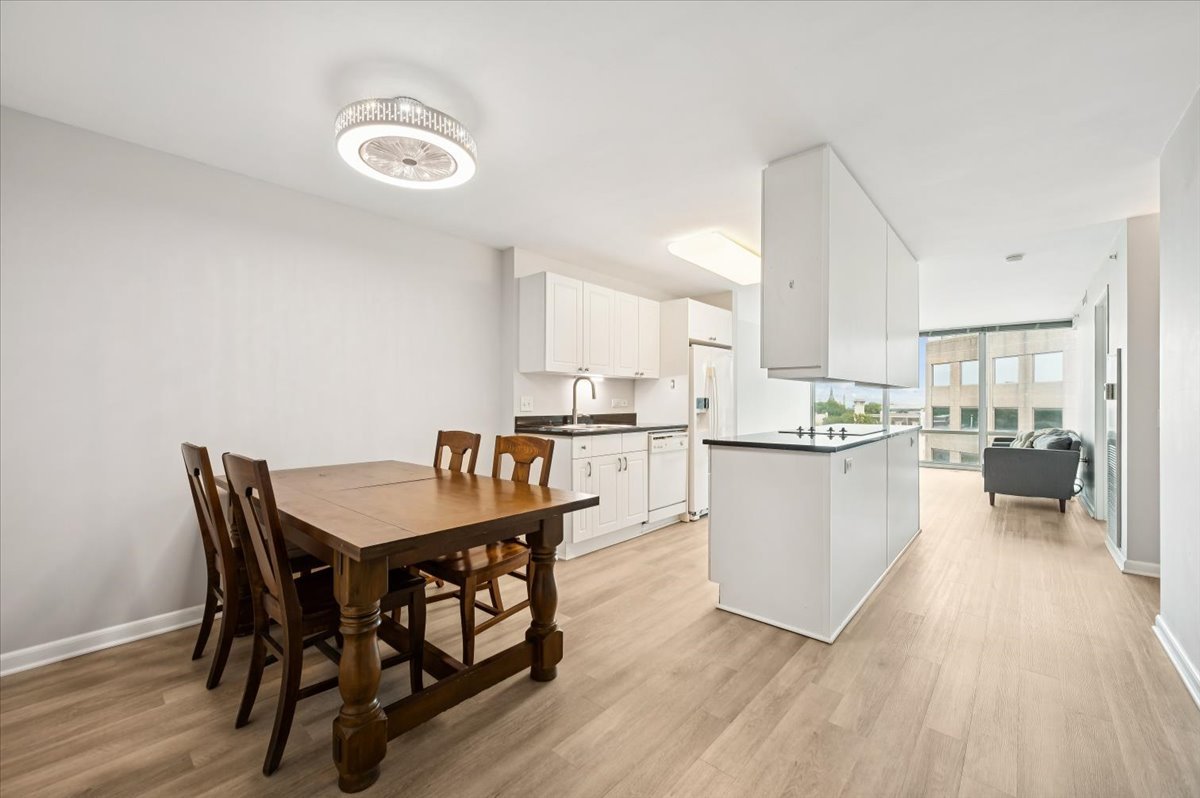 800 Elgin Road, Unit 1013 Evanston, IL 60201 - Photo 5 of 25 a kitchen with a table and chairs in it