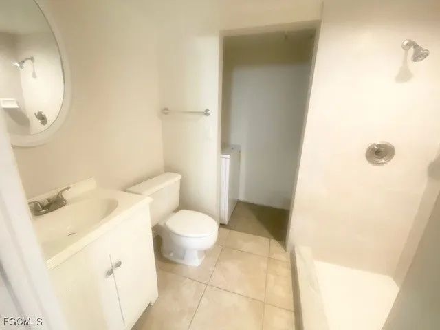 an empty room with a ceiling fan and window