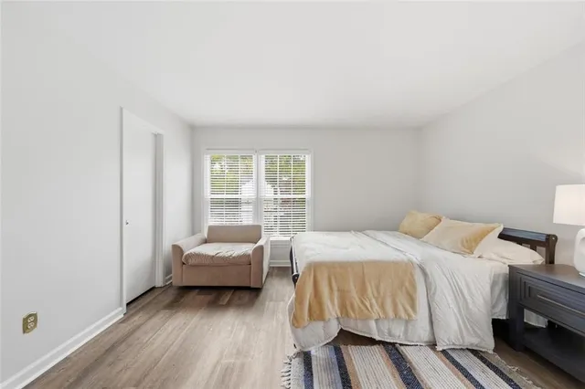 a bedroom with a bed a table and chair