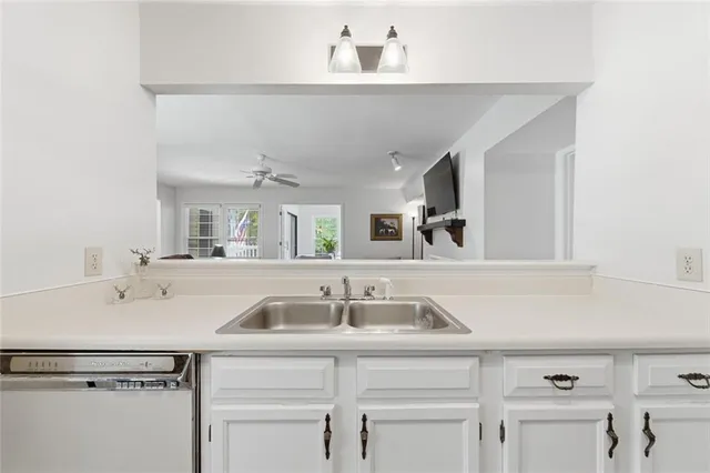 a kitchen with a stove and white cabinets
