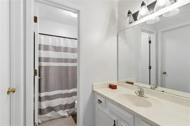 a front view of a house with a yard and potted plants