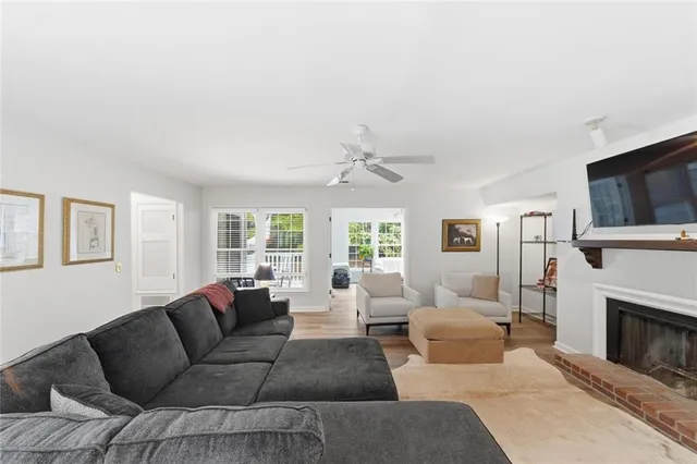 a living room with furniture a fireplace and a flat screen tv