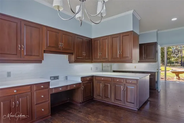 a kitchen with a sink cabinets and wooden floor