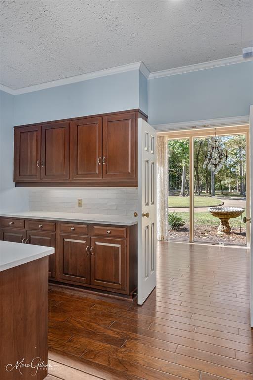 10405 Ellerbe Road Shreveport, LA 71106 - Photo 14 of 40 a kitchen with granite countertop a stove a sink and a microwave