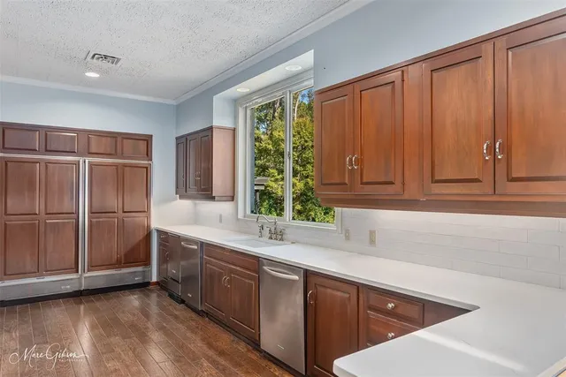 a kitchen with stainless steel appliances kitchen island granite countertop a sink window and cabinets