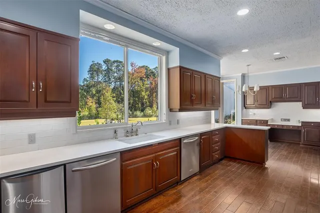 a kitchen with lots of counter top space and wooden floor