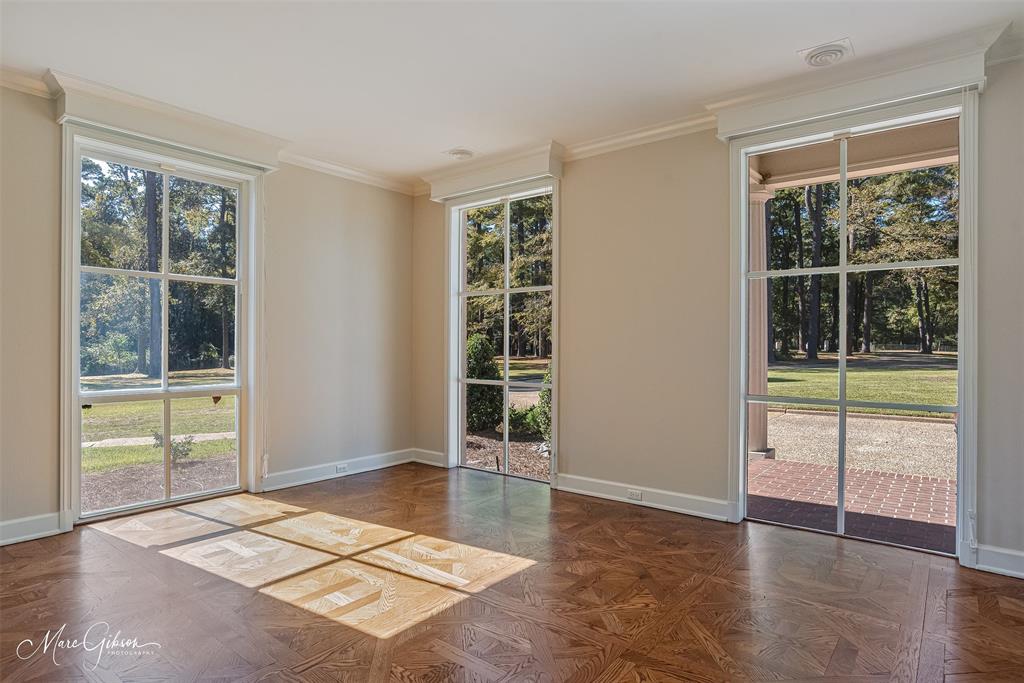 10405 Ellerbe Road Shreveport, LA 71106 - Photo 20 of 40 a view of an empty room with a window and wooden floor