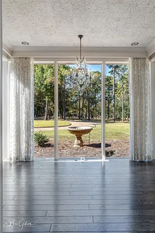 a view of a room with wooden floor and windows