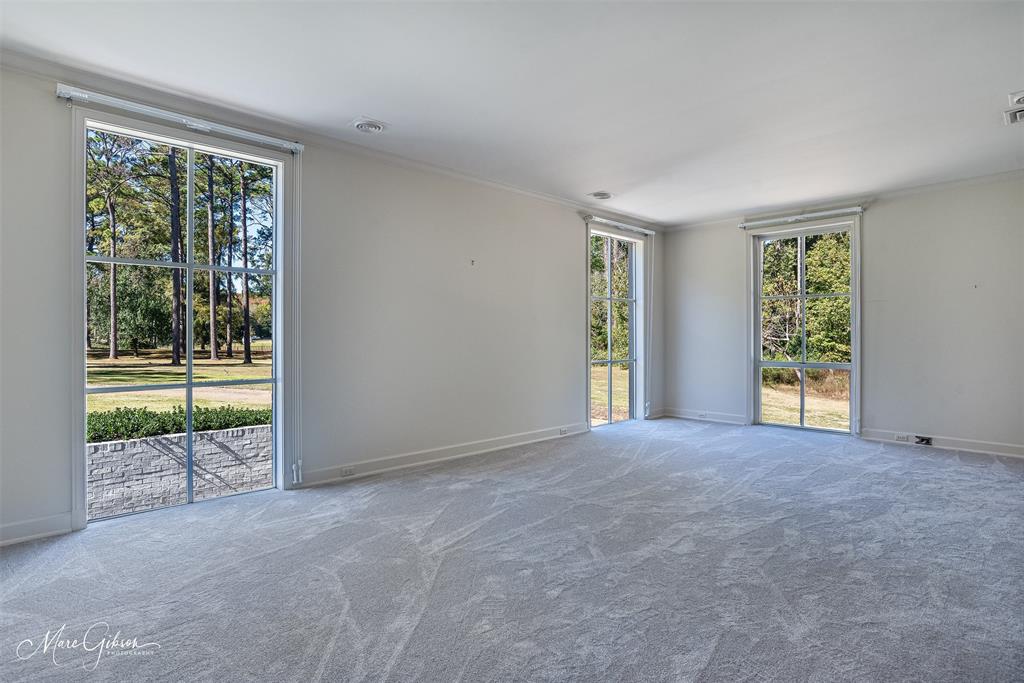 10405 Ellerbe Road Shreveport, LA 71106 - Photo 28 of 40 a view of an empty room with wooden floor and a window