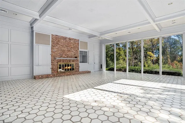 a bedroom with a bed and a large window with outer view