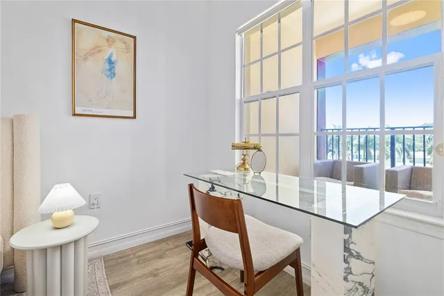 a dining room with furniture and a window
