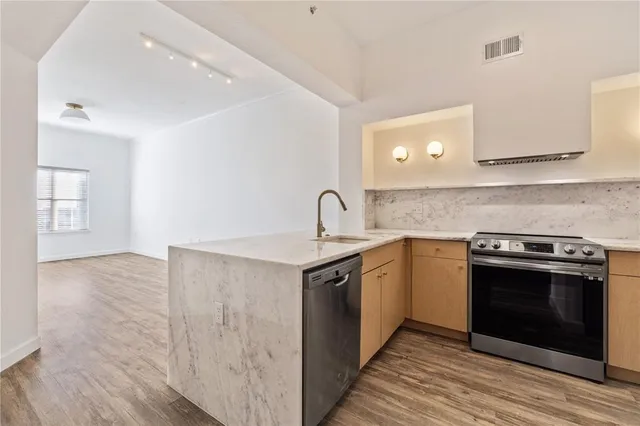 a kitchen with a stove and a sink