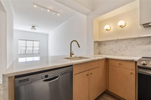 a kitchen with a sink cabinets and window