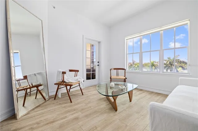 a living room with furniture and a floor to ceiling window
