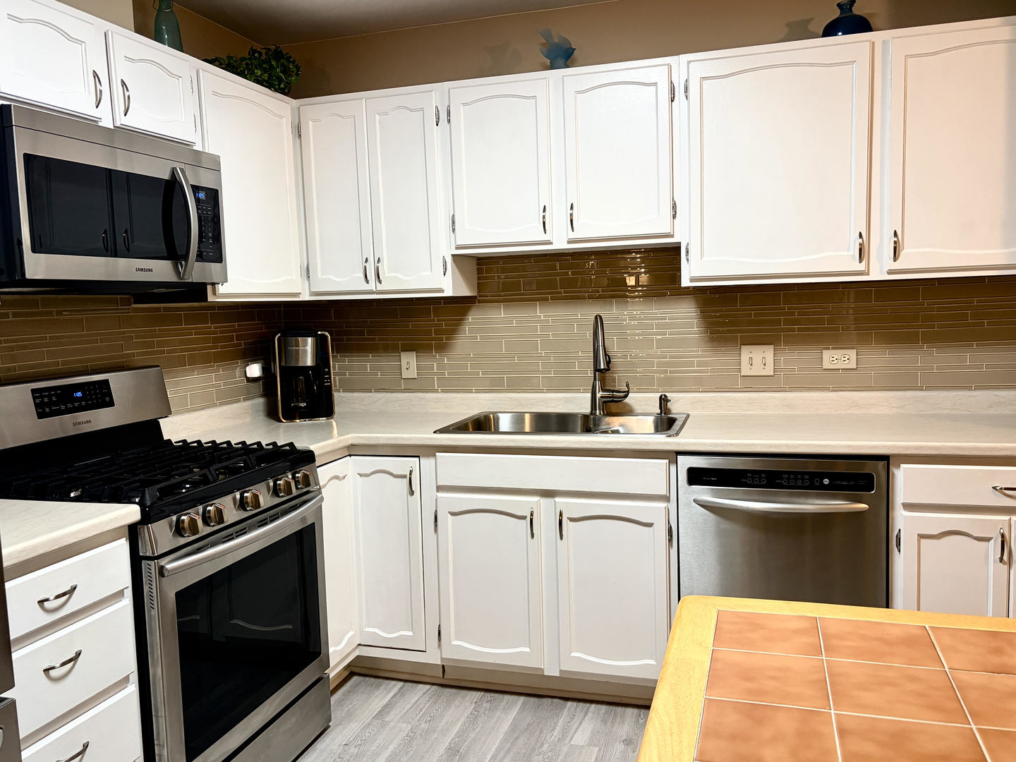 300 East Dundee Road, Unit 102A Buffalo Grove, IL 60089 - Photo 4 of 27 a kitchen with stainless steel appliances granite countertop a sink and a stove