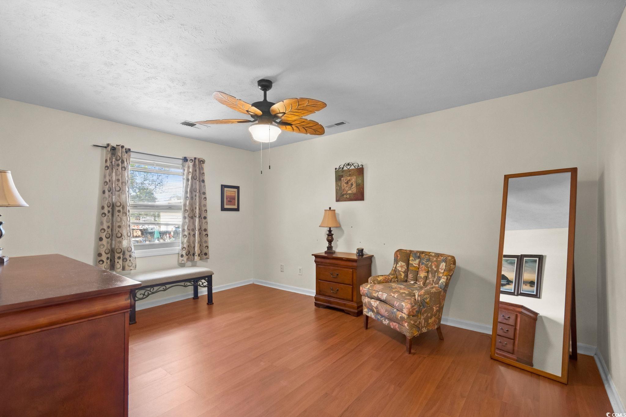 406 75th Avenue North, Unit Q Myrtle Beach, SC 29572 - Photo 12 of 23 Living area with wood finished floors, ceiling fan, and a textured ceiling