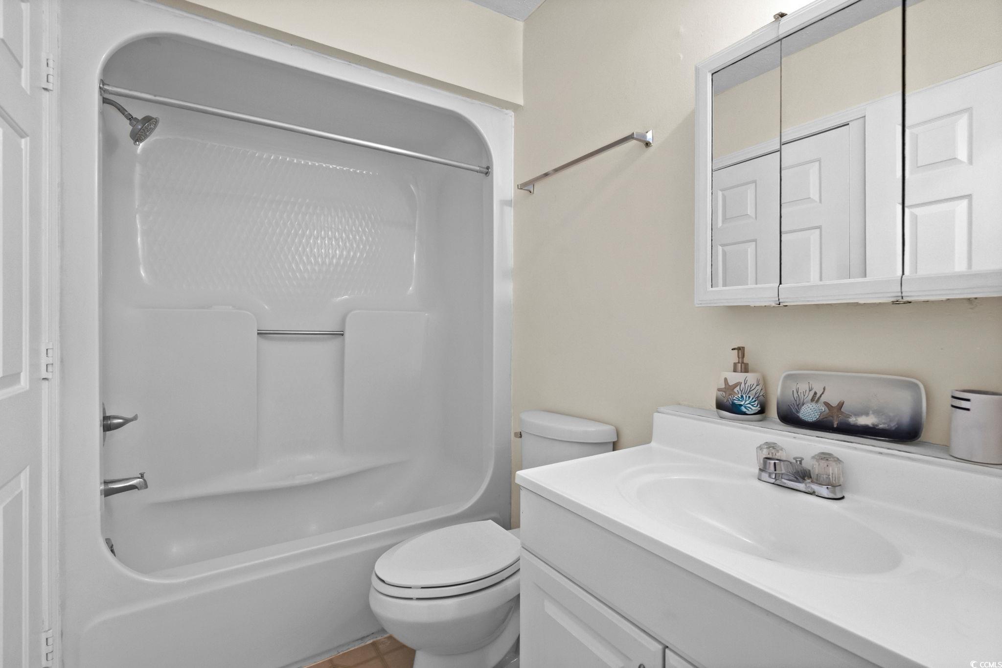 406 75th Avenue North, Unit Q Myrtle Beach, SC 29572 - Photo 19 of 23 Bathroom with vanity, washtub / shower combination, and light tile patterned floors