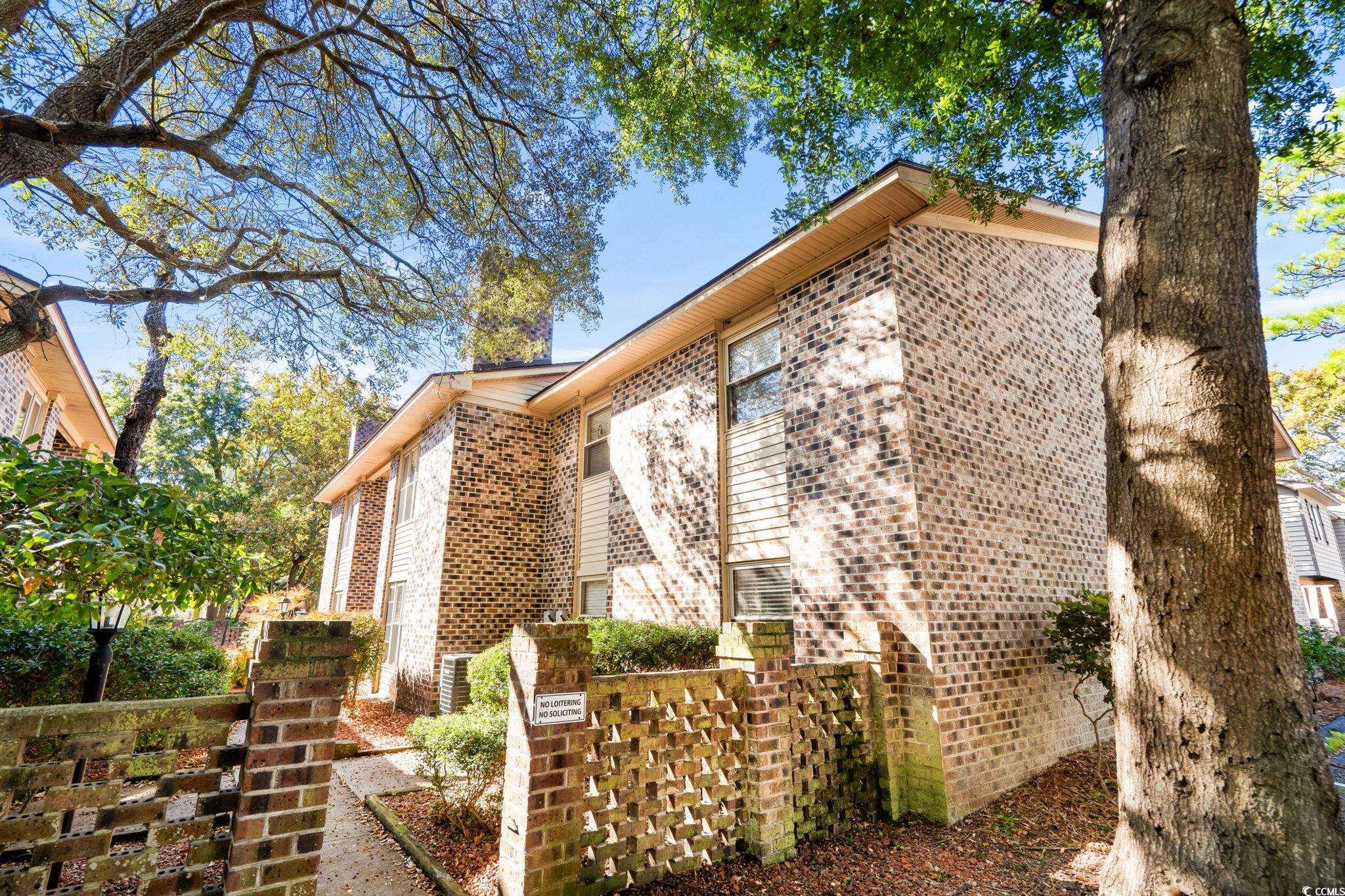 406 75th Avenue North, Unit Q Myrtle Beach, SC 29572 - Photo 21 of 23 View of property exterior with brick siding